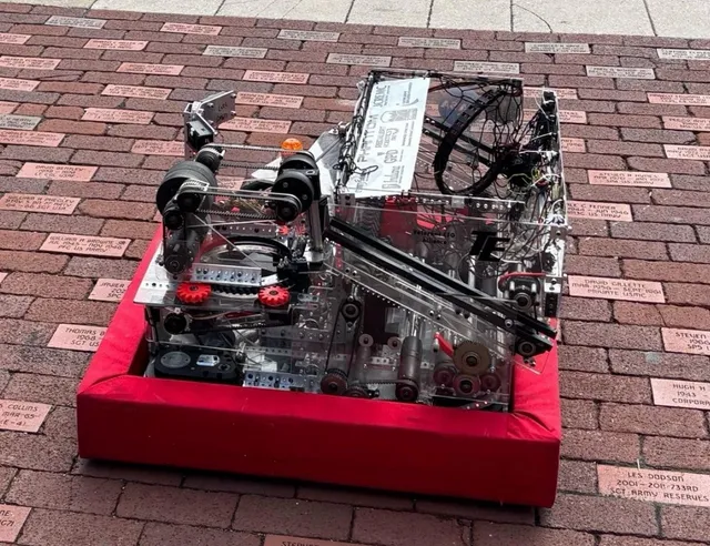 The 2026 competition robot with red bumpers, exposed mechanisms, and wiring.